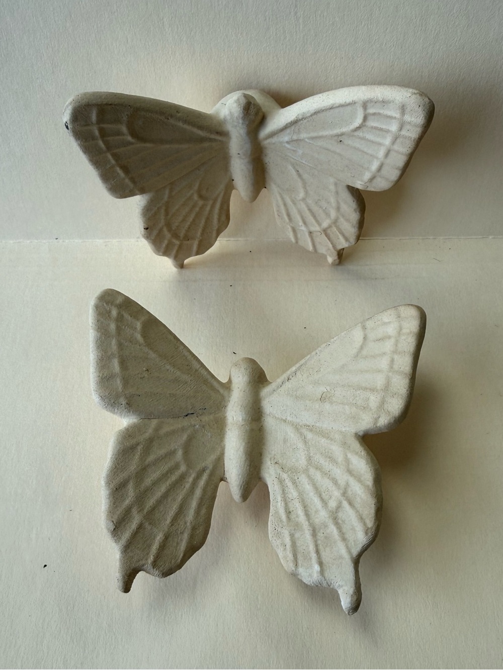 Pair of Bisque Beige Concrete Like Folk Art Butterfly Wall Hangings.